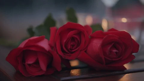 Bouquet of red roses placed on the table in the night Stock Footage 124100323