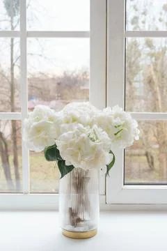 Bouquet of white artificial decorative hydrangea, hortensia in vase on wind.. Stock Photos
