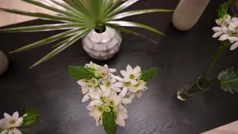 Bouquet of white flowers on table slow camera zoom in and out Stock Footage 194791444