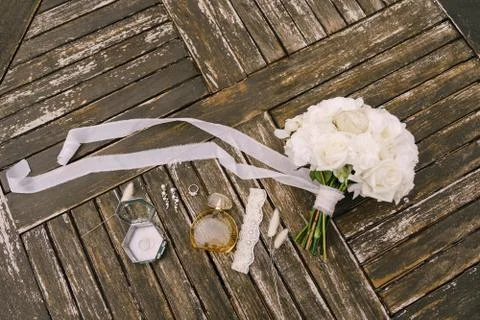 Bouquet of white roses with a long developing ribbon for the bride with garter Stock Photos