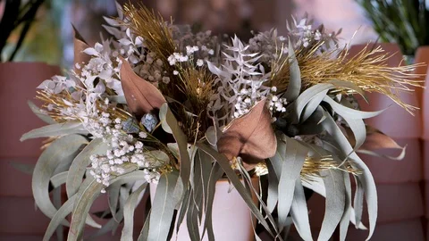 Bouquet with white statice flower, eucalyptus and other plants and leaves Stock Footage 128340085