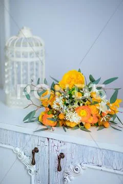 Bouquet of yellow flowers on a white vintage nightstand Stock Photos