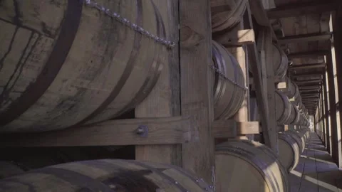 Bourbon Whiskey Barrels aging inside rick house in Kentucky Stock Footage 240028170