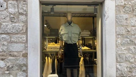 Boutique Window Display in Ancient Limestone Facade Stock Footage 328009229