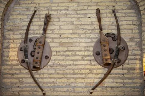 Bow and arrow in wall Fotos de archivo