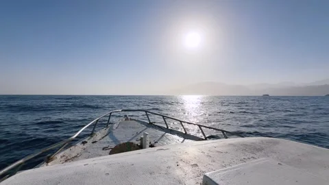 Bow of Boat Sailing on Open Sea at Sunset with Sun Glare on Water Vídeos de archivo 341910557