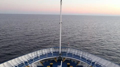 The bow of the cruise ship cuts through the sea, heading towards the mainland Stock Footage 346770113