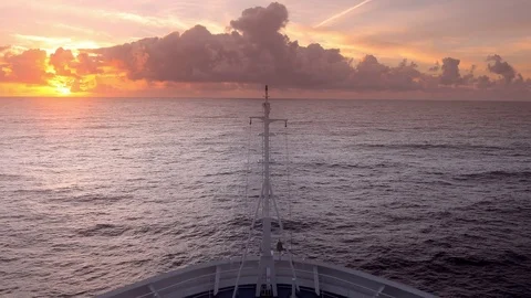 Bow of cruise ship moving over waves toward sunrise Stock-Footage 83599532