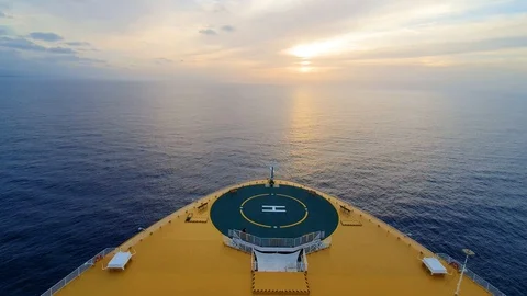 Bow of cruise ship moving over water toward sunrise Stock Footage 116205426