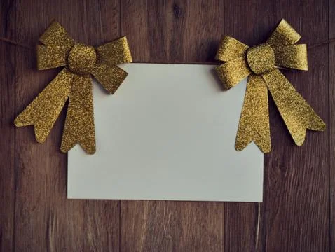 Bow Decorations with text space on white paper on a wooden background. Vintage Stock-Fotos