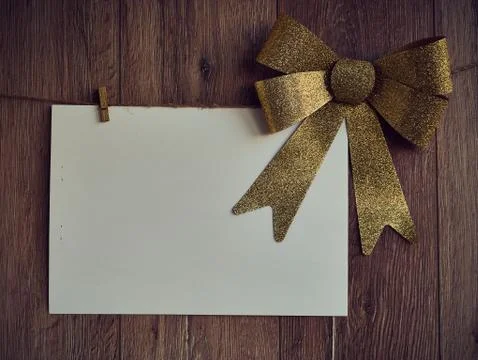 Bow Decorations with text space on white paper on a wooden background. Vintage Stock Photos