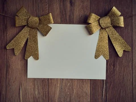 Bow Decorations with text space on white paper on a wooden background. Vintage Stock Photos