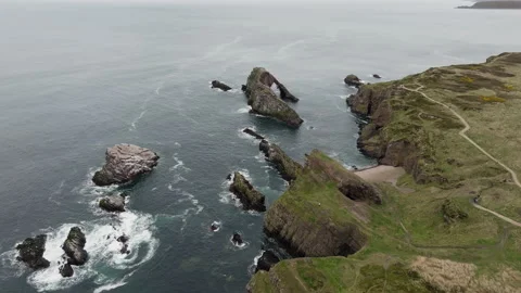 Bow Fiddle Rock sea stacks waves near Portknockie aerial Stock Footage 333351549