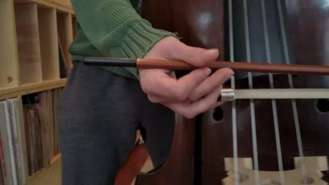 The bow-hand of a double bass player while practising Stock Footage 134840432