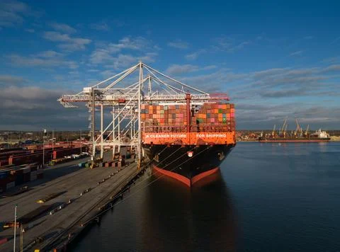 Bow of Hapag-Lloyd container ship at sunset Southampton Docks UK orange sign Stock Photos