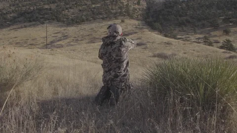 Bow Hunter Aims and Draws Arrow in Mountains Stock Footage 123399133