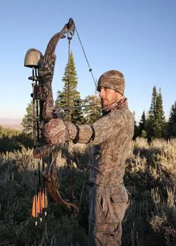 Bow hunter drawing bow closeup Stock Photos