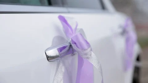 Bow made of a sacking on doors of the wedding car Stock Footage 90665394