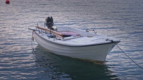 Bow of an old boat with peeling paint that floats on water on pier, swimming on Stock Footage 222977835