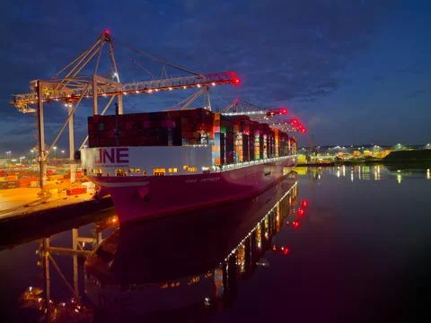 Bow of One container ship at night at Southampton Docks UK aerial lights Stock Photos