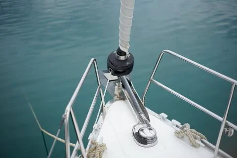 Bow-prow with rolled up fore sail against turquoise blue mediterranen sea Stock Photos