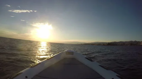 Bow of a rubber boat navigating at the sunset Stock Footage 67574661