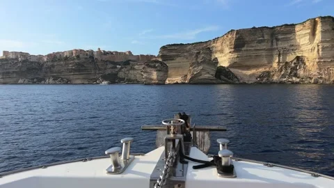Bow of sailing boat navigating toward bonifacio cliffs, corsica Stock Footage 278921596
