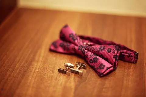 Bow tie and cufflinks on table Stock Photos