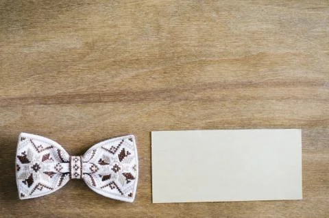 Bow Tie and Empty Card on Wooden Background. Stock Photos