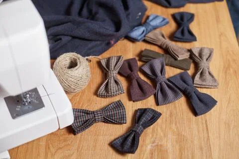 Bow ties made of wool on oak wooden table, adds a finished product. Small craft Stock Photos