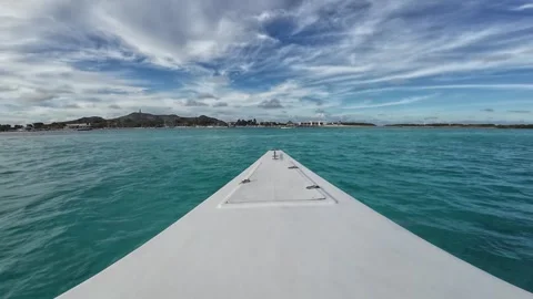 Bow view sailing through crystal-clear turquoise Caribbean waters towards Gran Stock Footage 344077473