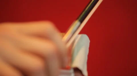 Bow for the violin on a red background Stock Footage 61035686