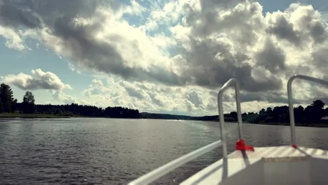 Bow of a white boat cutting through large waves as it speeds toward the blue Stock Footage 307770010