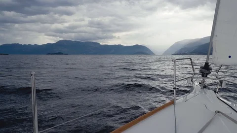 Bow of white sailing yacht while traveling by sea in Norway in cloudy weather Stock Footage 91097071