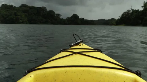 The bow of a yellow kayak sailing down the river in cloudy weather. Stock Footage 138659083