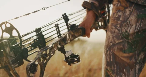 Bowhunter confidently carries his livelihood Stock Footage 101125677