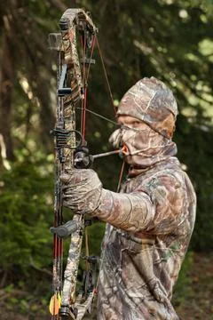 Bowhunter drawing bow close-up Stock Photos