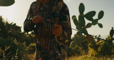 Bowhunter walks stealthily with his bow at the ready Stock Footage 101128142