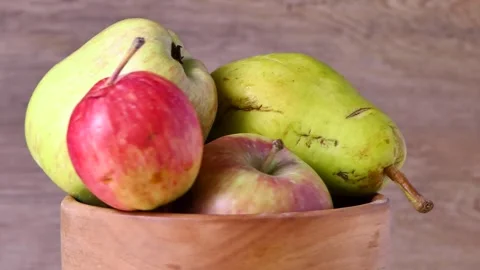 A bowl of apples rotating on a board Stock Footage 248387635