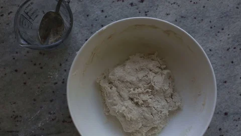 Bowl of batter with measuring cup Видео 79647460