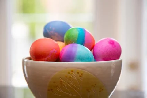 Bowl of brightly colored Easter eggs on diplay Stock Photos
