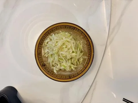 A bowl of cabbage soup on a white table. Stock Photos