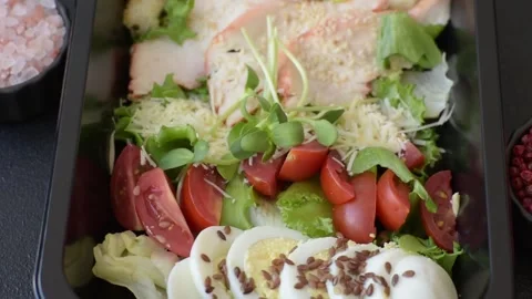 Bowl with caesar salad with chicken, parmesan cheese, tomatoes, croutons, lettuc Stock Footage 308531374