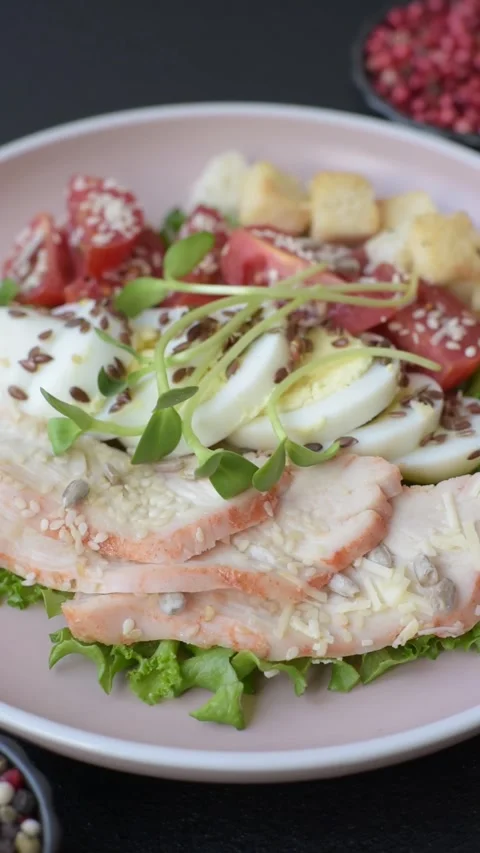 Bowl with caesar salad with chicken, parmesan cheese, tomatoes, croutons, lettuc Stock Footage 308531396