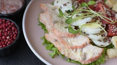 Bowl with caesar salad with chicken, parmesan cheese, tomatoes, croutons, lettuc Stock Footage 308531401