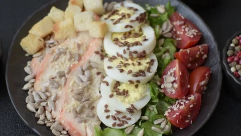 Bowl with caesar salad with chicken, parmesan cheese, tomatoes, croutons, lettuc Stock Footage 308531402