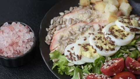 Bowl with caesar salad with chicken, parmesan cheese, tomatoes, croutons, lettuc Stock Footage 308531408