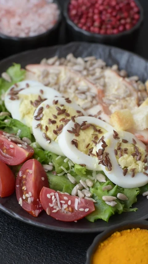 Bowl with caesar salad with chicken, parmesan cheese, tomatoes, croutons, lettuc Stock Footage 308531410