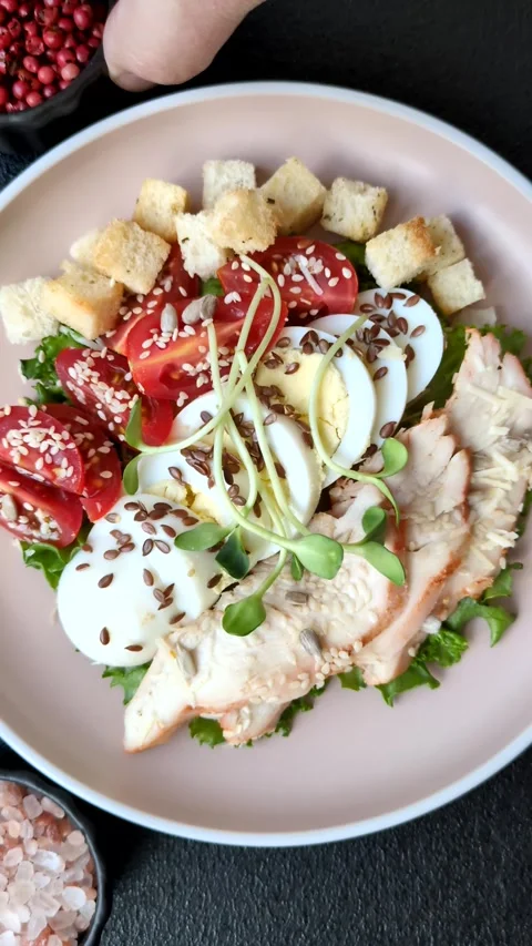 Bowl with caesar salad with chicken, parmesan cheese, tomatoes, croutons, lettuc Stock Footage 308531479