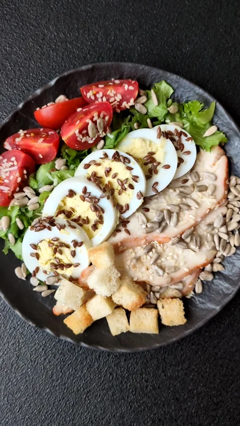 Bowl with caesar salad with chicken, parmesan cheese, tomatoes, croutons, lettuc Stock Footage 308531484